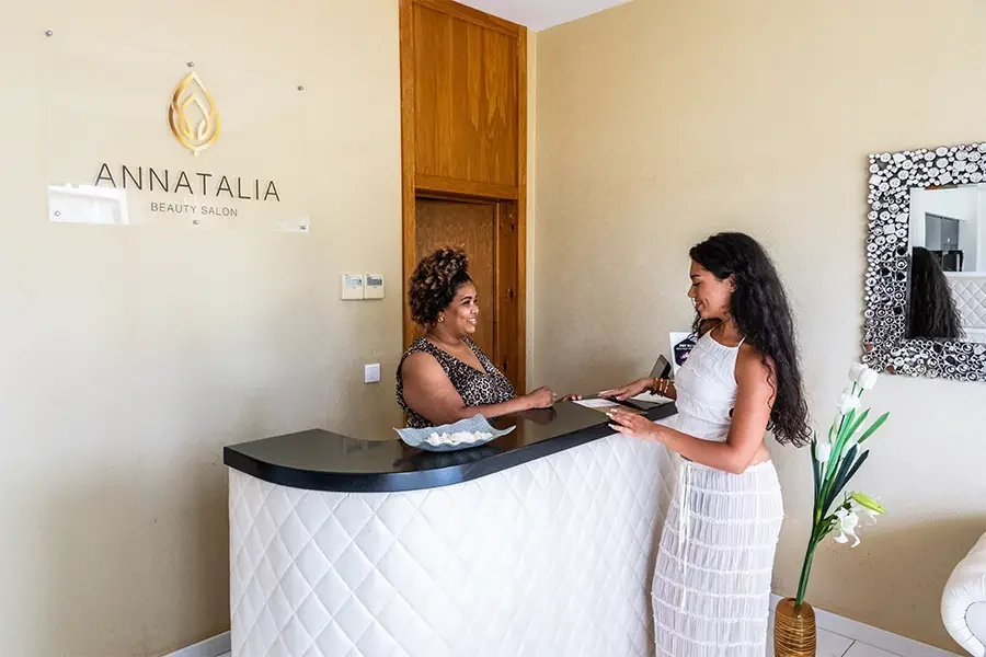 Woman standing at the counter of Annatalia beauty salon